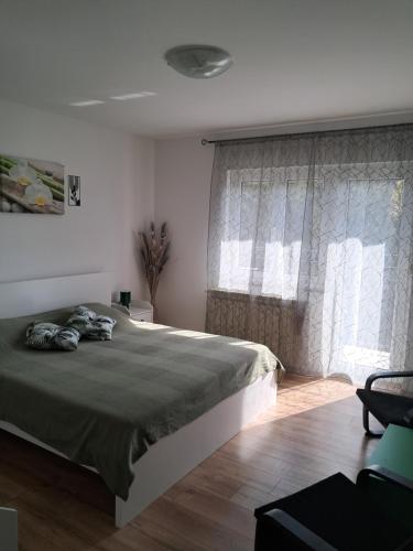 a bedroom with a large bed and a window at SAN MARKO 2 in Lovran