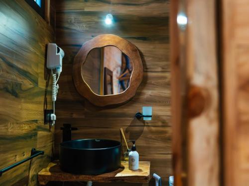 a bathroom with a sink and a mirror at Seashore Beach hotel and Bungalow in Kumba Urembo