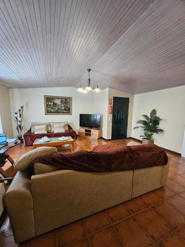 a living room with a large bed and a couch at Villa Dourada in Porto Santo
