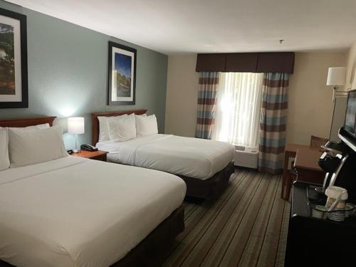 a hotel room with two beds and a television at White Pine Lodge in Salamanca