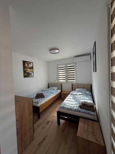 a room with two beds and a window at Domek na łowisku in Adamówka