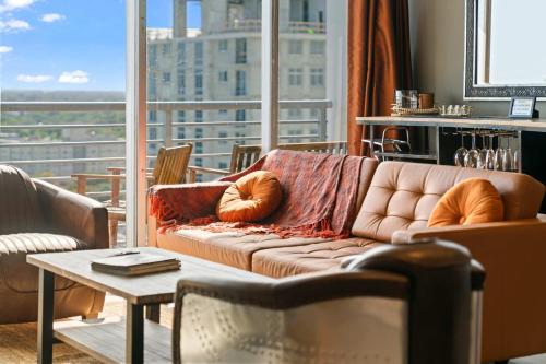 a living room with a couch and a table at Hollywood Beach Speakeasy Condo with Pool in Hollywood