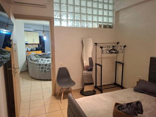 a room with a bed and a chair in it at Le Rocher 3 in Ermoupoli