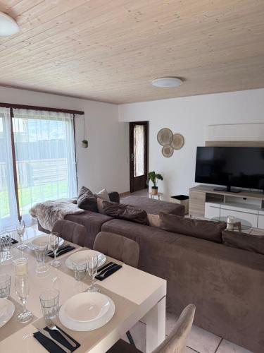 a living room with a couch and a table at Angolo del Tramonto in Gambarogno