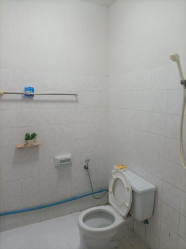 a white bathroom with a toilet and a shower at hatyai homestay greenway orkar in Hat Yai