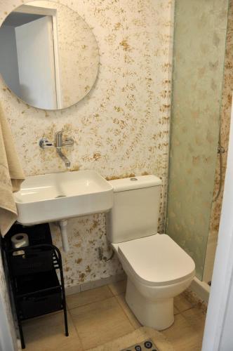 a bathroom with a white toilet and a sink at Georgias house in Yerakiní