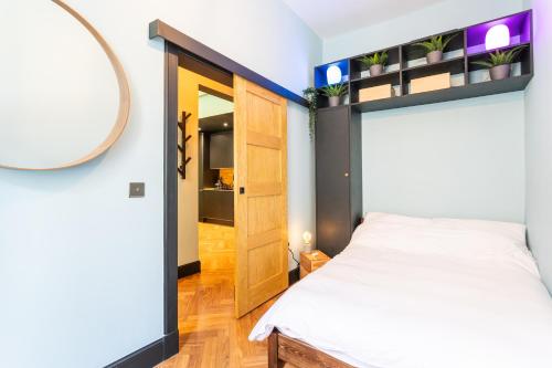 a bedroom with a bed and a mirror at Edinburgh Centre - Holyrood Apartment in Edinburgh