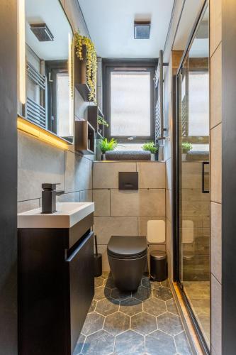 a bathroom with a toilet and a sink at Edinburgh Centre - Holyrood Apartment in Edinburgh