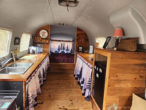 a kitchen with wooden counters and a sink in a trailer at Orange Lake Airstream in Whiting