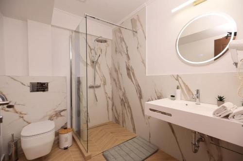 a bathroom with a toilet and a sink and a mirror at Pensiunea Cavaler in Baile Felix