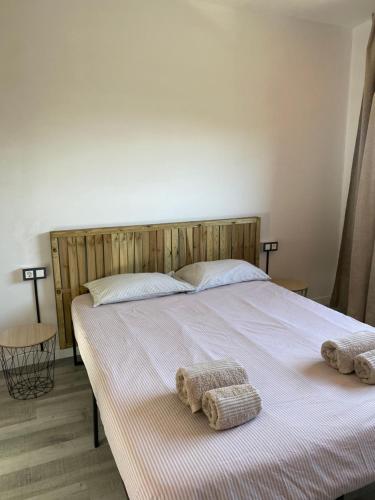 a bedroom with a large bed with towels on it at Green House in Llagostera