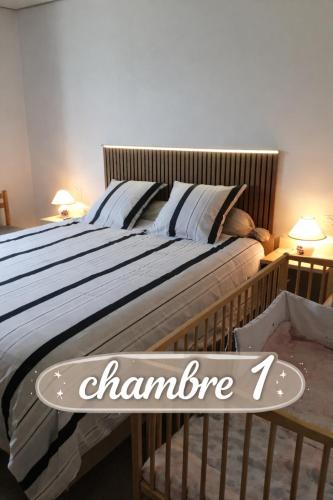 a bed with a sign that says chambonne on it at Bienvenue dans notre maison in Saint-Georges-dʼOléron