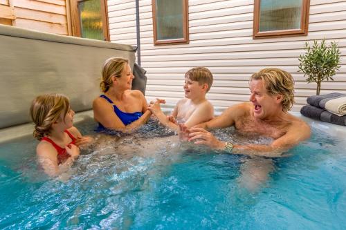 a group of people in a hot tub at Aberdunant Hall Holiday Park, Snowdonia in Porthmadog