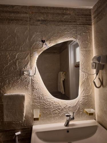 a bathroom with a sink and a mirror at Elite Apartment In Cairo Downtown in Cairo