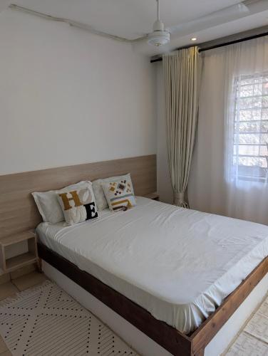 a bedroom with a large bed in a room at Belle Atelier in Ukunda