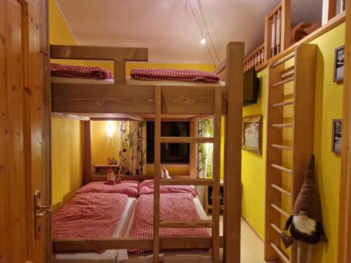 a bunk bed in a room with two bunk beds at Holzfällerhaus Melkstatt in Auffach