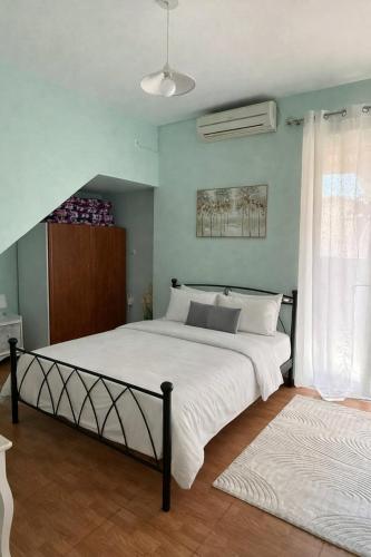 a bedroom with a large bed with white sheets at Casa Marianna-Luxury Riviera Retreat in Anavyssos