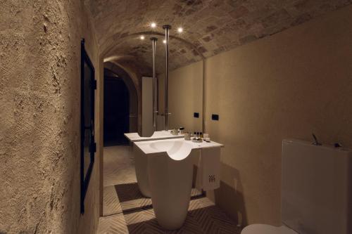 a bathroom with a sink and a mirror at Il Palazzotto I Residence & Winery in Matera