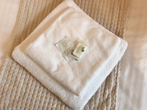 a white towel sitting on top of a bed at Hotel Zlatý Kříž in Teplice