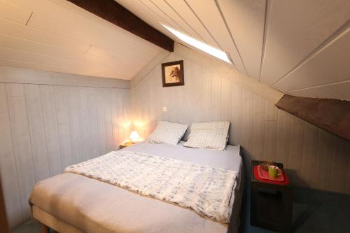 a small bedroom with a bed in the attic at Appart Hotel cholet centre in Cholet