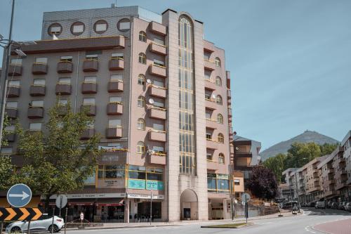 a tall building on the corner of a street at Casa do Rodrigo in Mondim de Basto