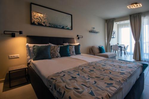 a bedroom with a large bed and a living room at Студия Морска хармония in Sozopol