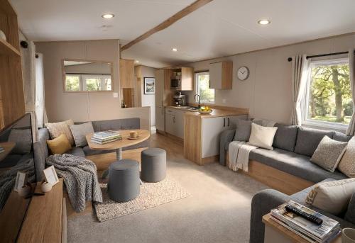 a living room with a couch and a table at Aberdunant Hall Holiday Park, Snowdonia in Porthmadog