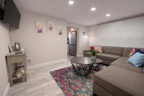 a living room with a couch and a table at NEW Beach Cozy Bungalow 2B Mins-beach&downtown in Clearwater