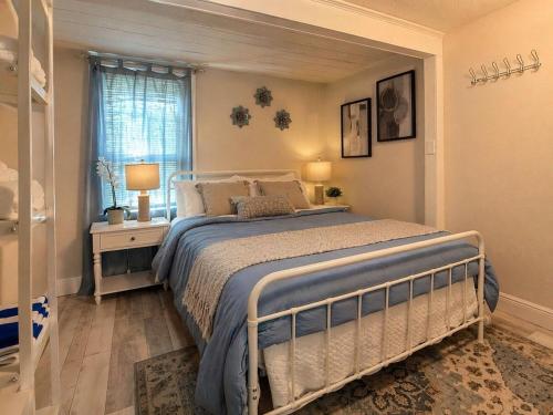 a bedroom with a large bed and a window at NEW Beach Cozy Bungalow 2B Mins-beach&downtown in Clearwater