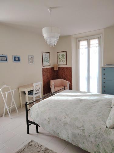 a bedroom with a large bed and a chandelier at Via Funicolare in Brunate