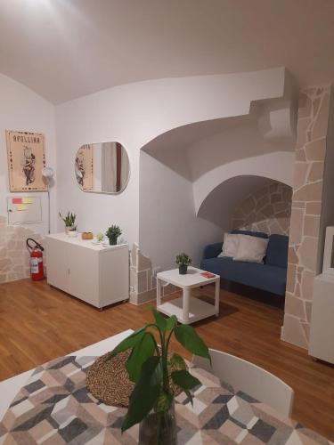 a living room with a couch and a table at La casetta nel cuore di Sciò in Gioia del Colle