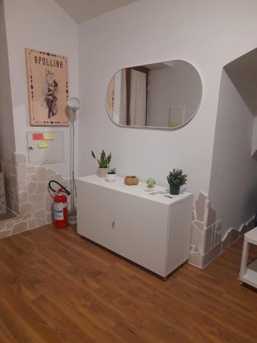 a room with a mirror and a white cabinet at La casetta nel cuore di Sciò in Gioia del Colle
