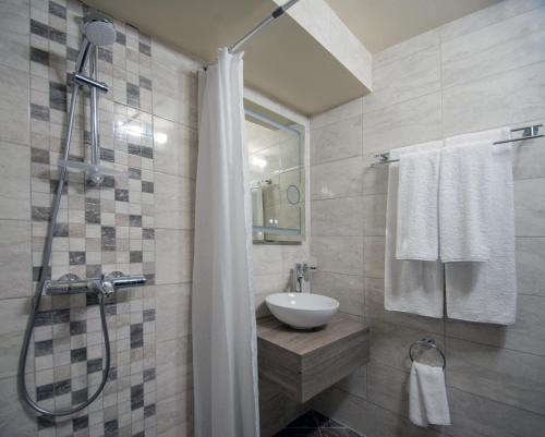 a bathroom with a sink and a shower at Студия Морска хармония in Sozopol