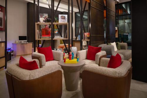 a lobby with two chairs with red pillows at Moxy Atlanta Downtown in Atlanta