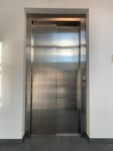 a metal elevator door in a building at Maisonette Wohnung am Tegernsee in Bad Wiessee