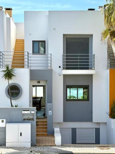 a white house with a staircase in front of it at Vila Rio DOuro in Ferragudo
