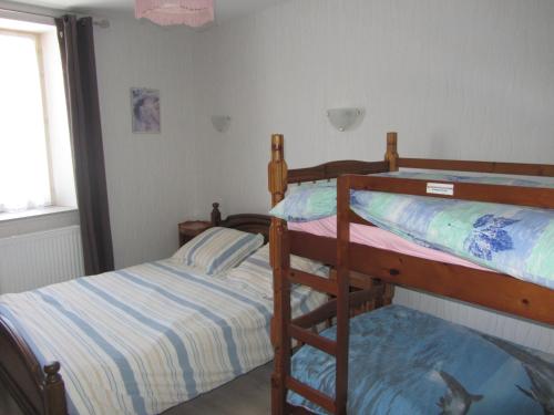 a bedroom with two bunk beds and a fish tank on the floor at Gites familiaux à Lajoux à 1180m d'altitude in Lajoux