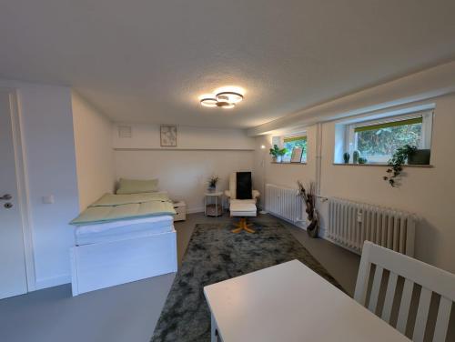 a room with a bed and a table in it at Gästezimmer am Deister in Barsinghausen