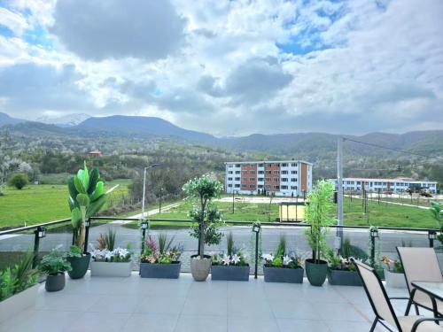 a balcony with potted plants and a view of a city at Villa Panorama View Brezovica in Brezovica