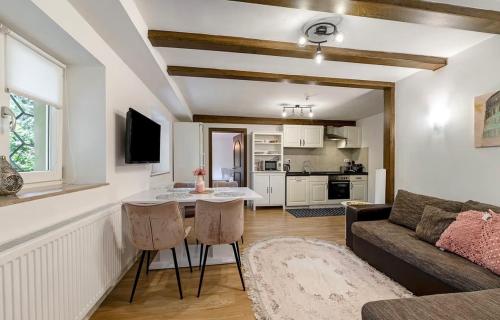 a living room with a couch and a table at Green House in Neunkirchen