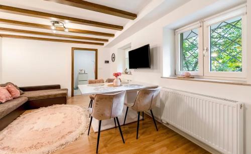 a living room with a table and chairs and a couch at Green House in Neunkirchen