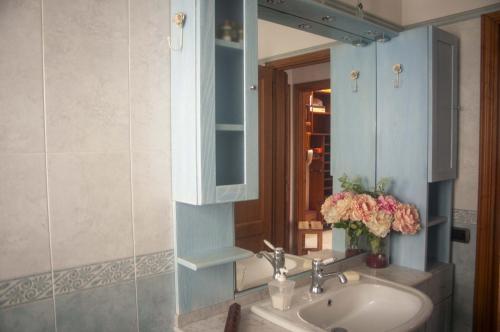 a bathroom with a sink and a mirror at Three Tails House in Capezzano Pianore,
