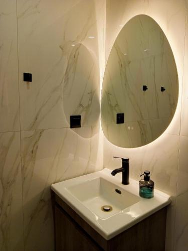 a bathroom with a sink and a mirror at Agave by Aloe Residence Possidi in Possidi