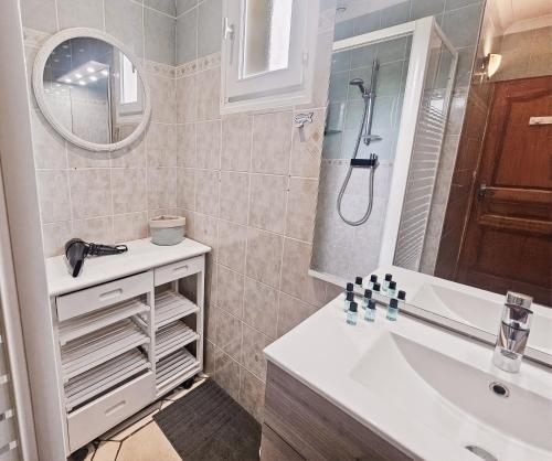 a bathroom with a sink and a shower at Villa La Dorada, Normandy in Ver-sur-Mer