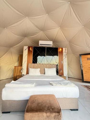 a bedroom with a bed in a tent at Wadi Rum Nader Luxury Camp in Wadi Rum