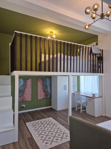 a loft bed in a room with a desk at Zion Central Apartment in Satu Mare