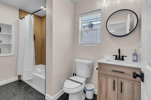a bathroom with a toilet and a sink and a mirror at Prof Cleaned | Linen+Towel | Pet Friendly | Coffee in Seaside Heights