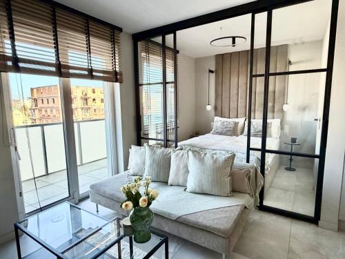 a living room with a couch and a bed at Apartamant Oaza II in Koszalin