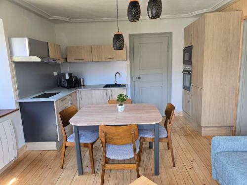 a kitchen and dining room with a table and chairs at Echappée Verte in Breitenbach-Haut-Rhin