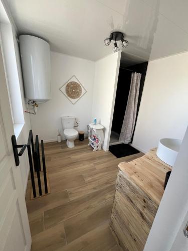 a bathroom with a toilet and a sink at Chez Raphaël et Hiba in Nesles